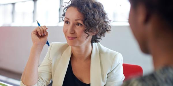Become a NAEYC Higher Education Accreditation Peer Reviewer Woman holding a pen