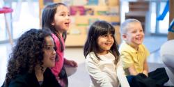 children listening to a person talking out of frame
